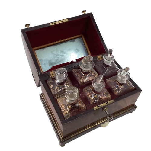 107 - A Victorian mahogany six bottle decanter box with domed lid, six glass decanters with original stopp... 