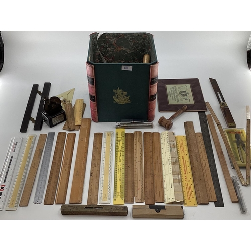 110 - A collection of measuring instruments to include Set Square, rulers etc