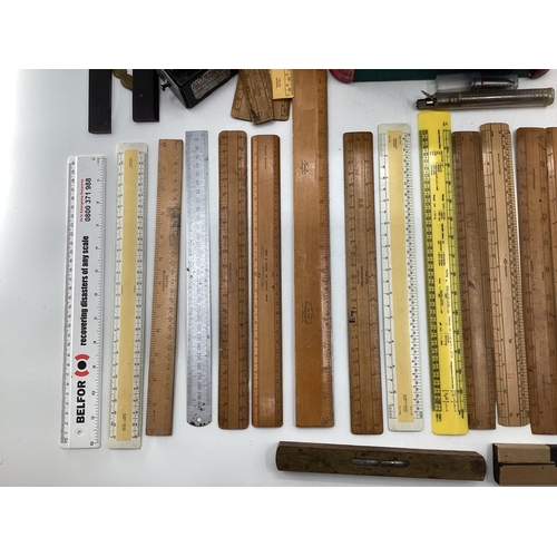 110 - A collection of measuring instruments to include Set Square, rulers etc