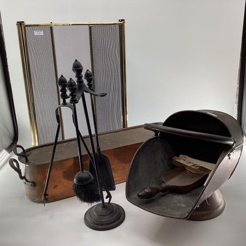 118 - A collection of fireside items, tools and stand, Helmet shaped scuttle, fire screen, large copper fi... 