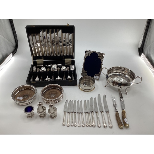 12 - Collection of electroplated and white metal items to include a pierced picture frame, cutlery and ot... 