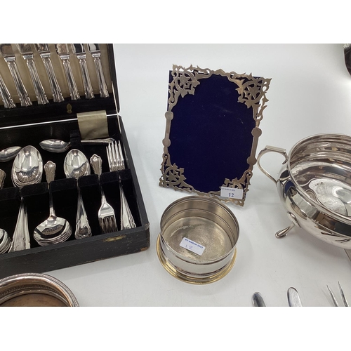 12 - Collection of electroplated and white metal items to include a pierced picture frame, cutlery and ot... 