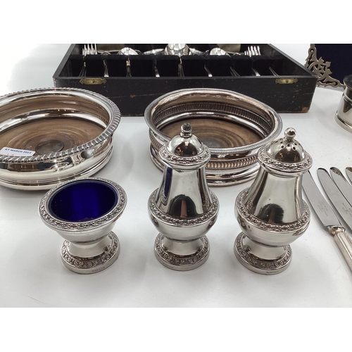 12 - Collection of electroplated and white metal items to include a pierced picture frame, cutlery and ot... 