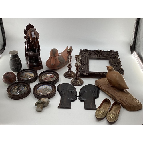 125 - A misc collection of items to include framed Pot Lids, West African hardwood items and C20th ceramic... 