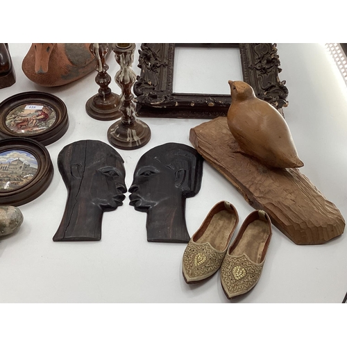 125 - A misc collection of items to include framed Pot Lids, West African hardwood items and C20th ceramic... 