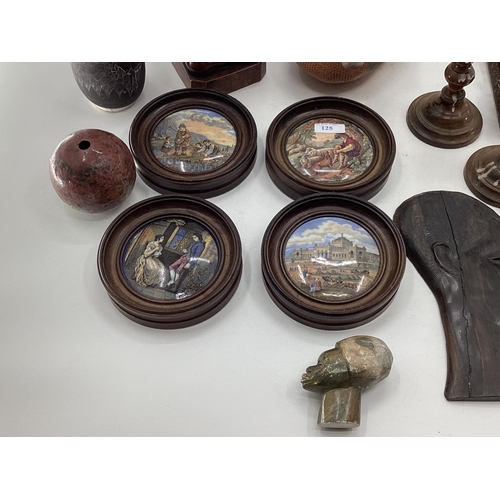 125 - A misc collection of items to include framed Pot Lids, West African hardwood items and C20th ceramic... 