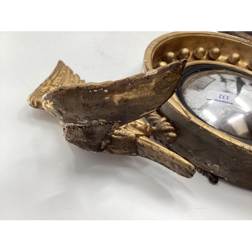 132 - Gilt wood convex mirror topped by a carved eagle, with 2 other mirrors