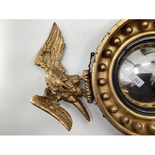 132 - Gilt wood convex mirror topped by a carved eagle, with 2 other mirrors