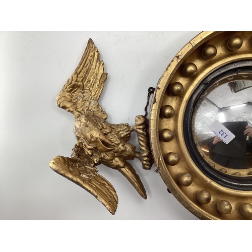 132 - Gilt wood convex mirror topped by a carved eagle, with 2 other mirrors