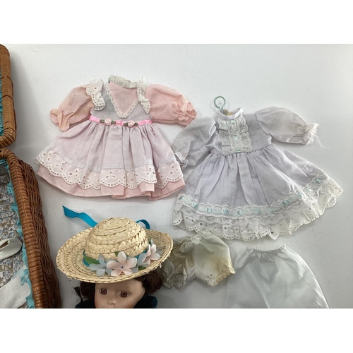 140 - Collection of dolls clothing and a porcelain doll