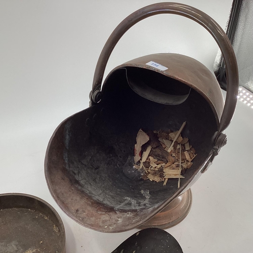 154 - A Helmet shaped copper coal scuttle