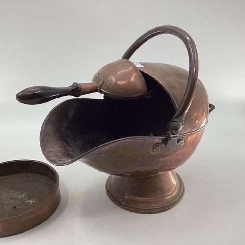 154 - A Helmet shaped copper coal scuttle