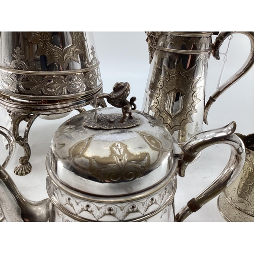 17 - A silver plated five piece tea set with ornate decoration, Bacchus mask spouts engraved to jugs with... 