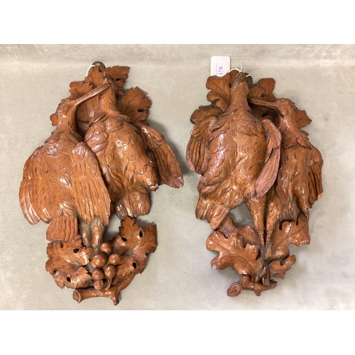 178 - A pair of carved wooden wall sconces , each depicting a pair of game birds on an oak branch, each ap... 