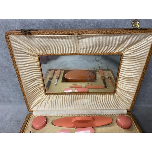 179 - A Mid C20th manicure set, in faux leather box, complete with mirror