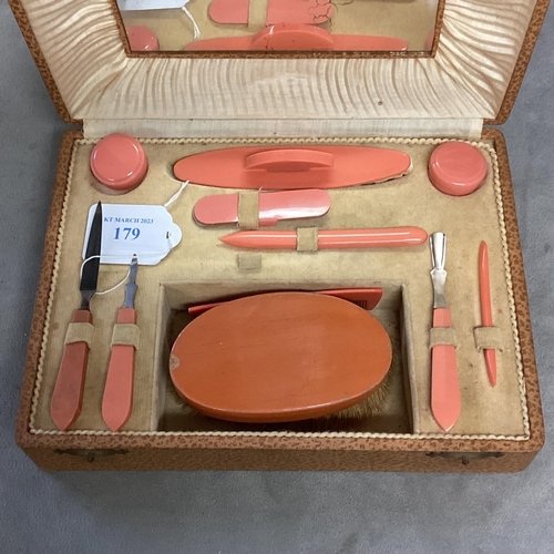 179 - A Mid C20th manicure set, in faux leather box, complete with mirror