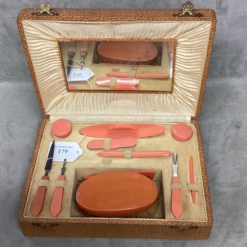 179 - A Mid C20th manicure set, in faux leather box, complete with mirror