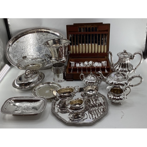 18 - A collection of silver plated wares to include a Campana style wine cooler, a 3 piece tea set and a ... 