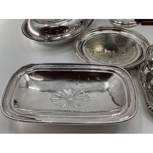 18 - A collection of silver plated wares to include a Campana style wine cooler, a 3 piece tea set and a ... 