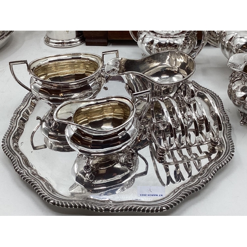 18 - A collection of silver plated wares to include a Campana style wine cooler, a 3 piece tea set and a ... 