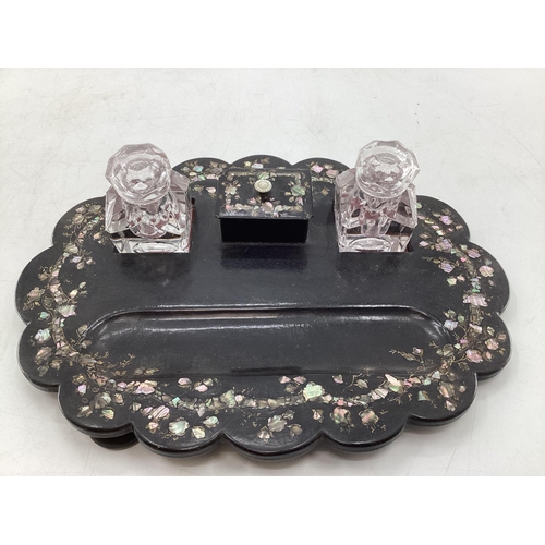 185 - A Victorian black lacquer and inlaid mother of pearl desk tidy/standish, with original glass inkwell... 