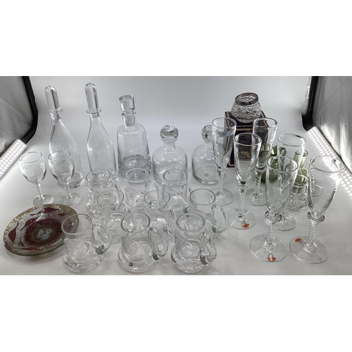 187 - A collection of modern glassware to include Dartington decanters, embossed mugs, 6 champagne flutes ... 