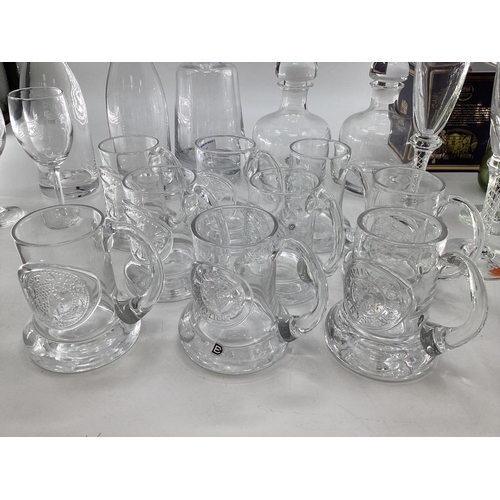 187 - A collection of modern glassware to include Dartington decanters, embossed mugs, 6 champagne flutes ... 