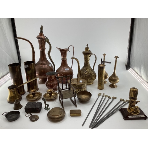 188 - A collection of metalware to include Middle Eastern style ewers, trench art and other items