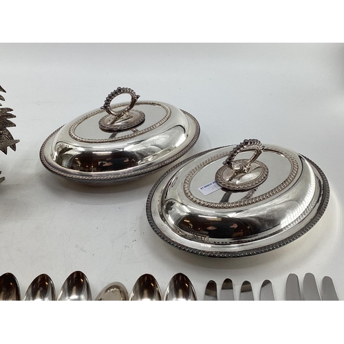 19 - A matched pair of silver plated table ornaments each 28cmH, and other silver plated wares, birds, fl... 