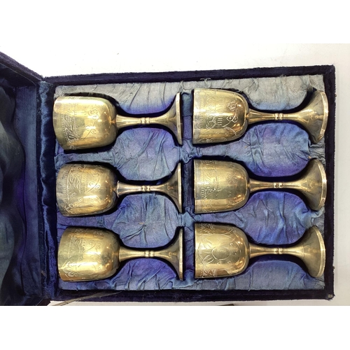 197 - A boxed set of six chased metal wine goblets together with a boxed decanter and four cups by Achen K... 