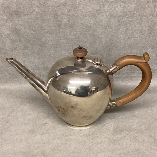 20 - A sterling silver boulle shaped tea pot, with fruitwood handle and knop, 13cmH, by A O London 1923, ... 