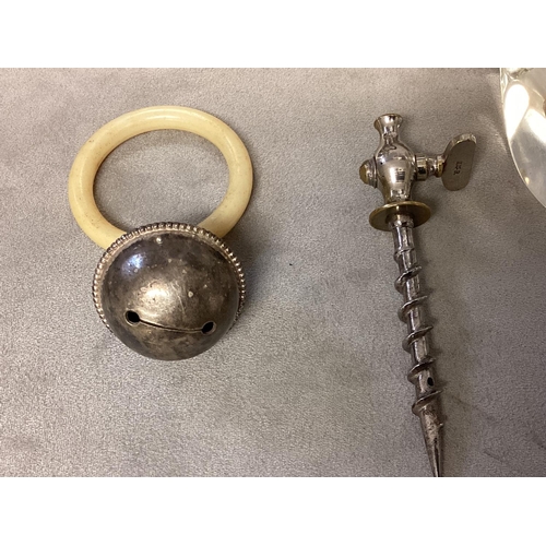 22 - A collection of unmarked white metal and silver plated items to include nutcracker, teething ring, 2... 