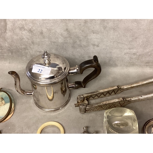 22 - A collection of unmarked white metal and silver plated items to include nutcracker, teething ring, 2... 