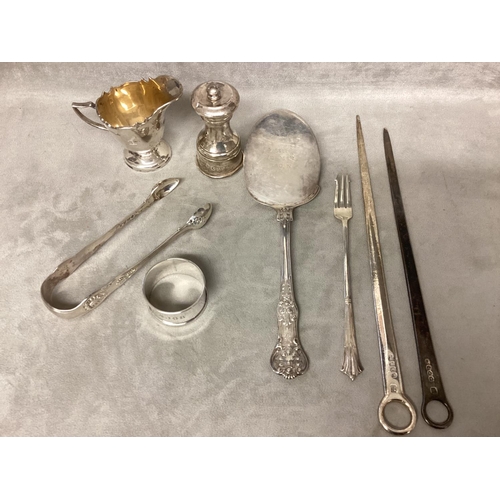 23 - A collection of sterling silver items to include Georgian letter openers, pepperette, cream jug, sug... 