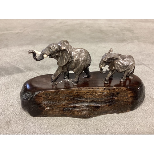 24 - PATRICK MAVROS, a silver and hardwood figure group, modelled as two elephants (damage to tusks) on a... 