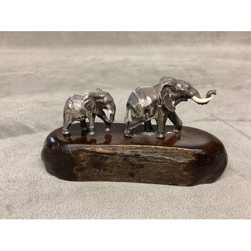 24 - PATRICK MAVROS, a silver and hardwood figure group, modelled as two elephants (damage to tusks) on a... 