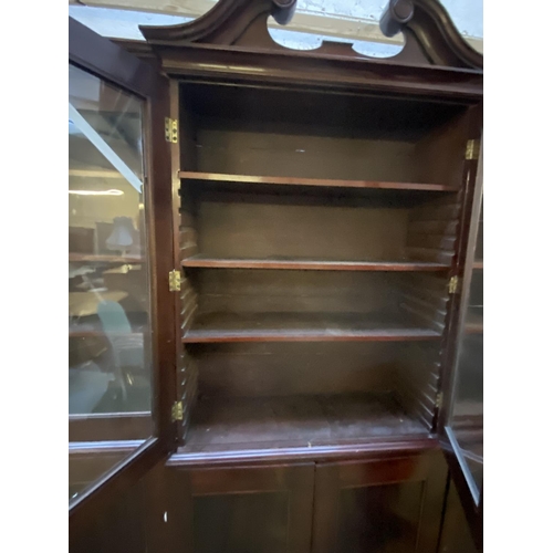 419 - A large late C19th mahogany three sectioned glazed library bookcase, the top with swan neck pediment... 