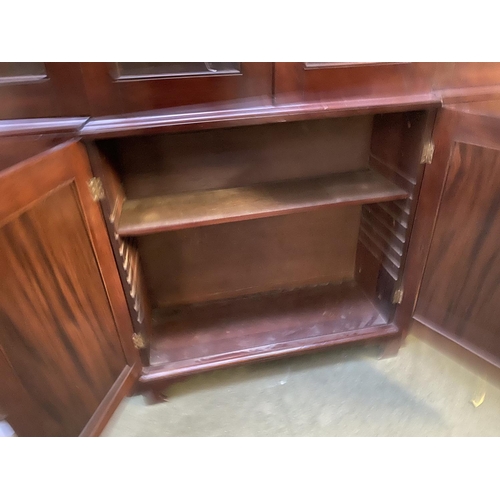 419 - A large late C19th mahogany three sectioned glazed library bookcase, the top with swan neck pediment... 