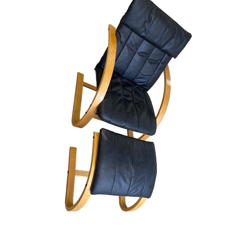 441 - Modern black leather and wooden armchair with footrest, SOME WEAR