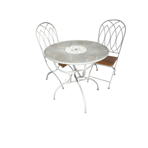 444 - A white metal bistro garden table, with two folding wooden slatted seated chairs  Dia 78cm x 77 cm H