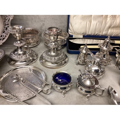 46 - A collection of silver plated items, candlesticks, pierced dish etc