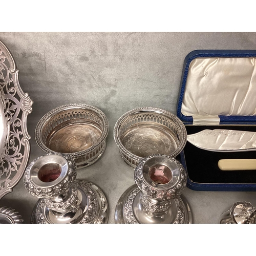 46 - A collection of silver plated items, candlesticks, pierced dish etc