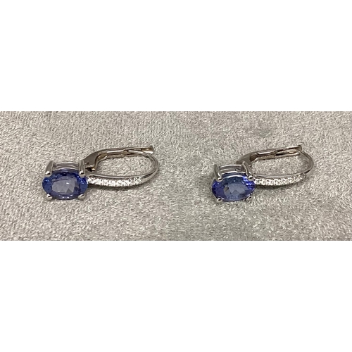 48 - A pair of unmarked white metal, Tanzanite earrings, with Bale set line of single cut diamonds (teste... 