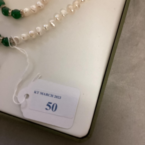 50 - A freshwater pearl jewellery suite, set with jade beads in original box