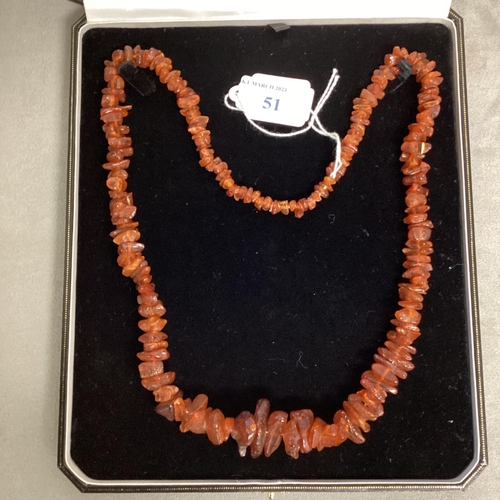 51 - An unpolished strand of graduated amber beads, 62cm