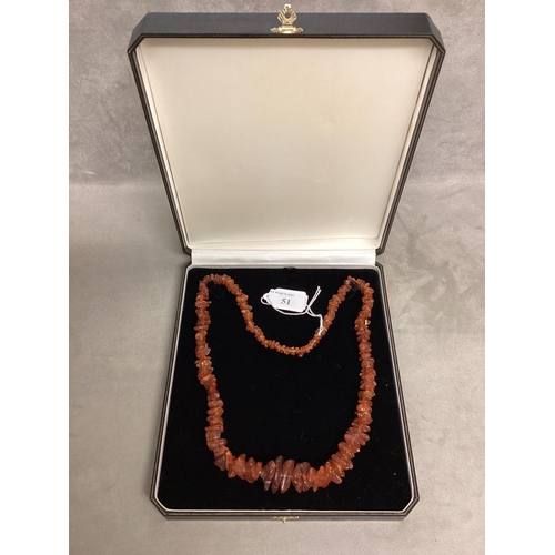 51 - An unpolished strand of graduated amber beads, 62cm