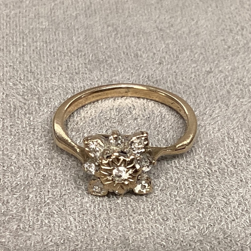 55 - An unmarked (rubbed) yellow and white metal diamond set flower ring, size L