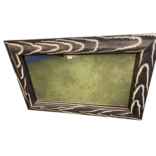 415 - A decorative rectangular wall mirror, framed in a faux  chenille brown and cream animal skin border