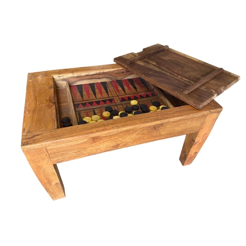 448 - A rustic low table, with inset top and lid opening to reveal a games table and counters 74cm W x 47c... 