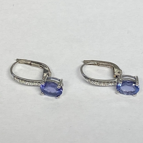 48 - A pair of unmarked white metal, Tanzanite earrings, with Bale set line of single cut diamonds (teste... 